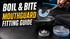 Boil-and-bite mouthguard held above hot water with fitting tools ready